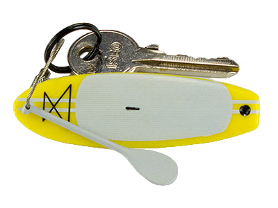 Keychain with a yellow miniature stand up paddleboard and keys on a white background